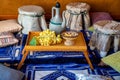 East. small table with jug and grapes. traditional textiles