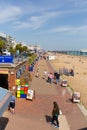 Eastbourne East Sussex England UK with people enjoying the spring sunshine walking on the seafront promenade