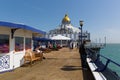 Eastbourne pier England with visitors in fine spring weather Royalty Free Stock Photo