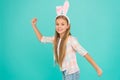 Easter activities. Cute bunny. Holiday bunny girl posing with cute long ears. Child smiling play bunny role. Bunny ears