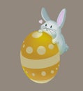 An adorable white cute rabbit climbs on the colourful Easter egg.