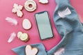 Easter aesthetics cookies and mockup of screen phone on pink background flat lay. Happy Easter