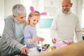 Easter, art and a girl painting with her grandparents in their home for love, bonding or celebration together. Family Royalty Free Stock Photo