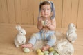 Easter Baby boy sitting on crib. Easter bunny. Children Protection Day. Happy childhood. Early child development. Educational