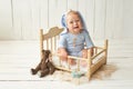 Easter Baby boy sitting on crib. Easter bunny. Children Protection Day. Happy childhood. Early child development. Educational
