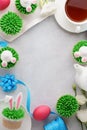 Easter background with bunny cupcakes, tea and painted eggs Royalty Free Stock Photo