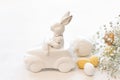 Easter background with a ceramic hare in the car and eggs on a white background, Royalty Free Stock Photo