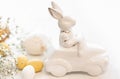 Easter background with a ceramic hare in the car and eggs on a white background, Royalty Free Stock Photo