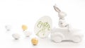 Easter background with a ceramic hare in the car and eggs on a white background, Royalty Free Stock Photo