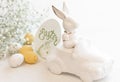 Easter background with a ceramic hare in the car and eggs on a white background, Royalty Free Stock Photo