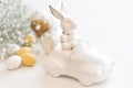 Easter background with a ceramic hare in the car and eggs on a white background, Royalty Free Stock Photo