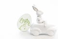 Easter background with a ceramic hare in the car. Royalty Free Stock Photo