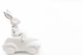 Easter background with a ceramic hare in the car. Royalty Free Stock Photo