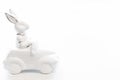 Easter background with a ceramic hare in the car. Royalty Free Stock Photo