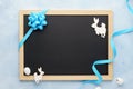 Easter background with chalkboard, blue ribbon and cute bunny