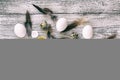 easter background with chicken quail one broken eggs and feathers on white wooden table, food top view Royalty Free Stock Photo