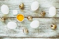 easter background with chicken quail one broken eggs on white wooden table, food top view Royalty Free Stock Photo