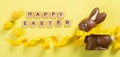 Easter background - chocolate bunny with yellow ribbon