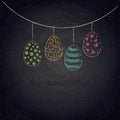 Easter background with colorful eggs on chalkboard