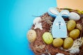 Easter background with colorful eggs in nest. Top view with copy space Royalty Free Stock Photo