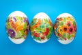 Easter background. Colorful paschal eggs with ornament on blue backdrop. Festive event. Spring season. Gift card, concept of