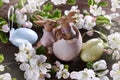 Easter background with cute bunny figurines and spring apple tree blossoms