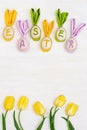 Easter background with decorative wooden eggs us fun bunny and word Easter is made of colorful letters Royalty Free Stock Photo