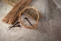 Easter background depicting the crucifixion with a rustic wooden cross, crown of thorns and nails. Royalty Free Stock Photo