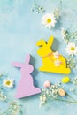 Easter background. Easter eggs cute bunny with Easter eggs and spring flowers.