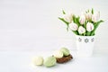 Easter background. Easter eggs and white tulips in vase. Copy space Royalty Free Stock Photo