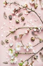 Easter background with eggs, almond flowers and feathers, vertical composition