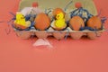 Easter background. Eggs and happy chickens in a basket on a blue straw on a pink background. Horizontal festive