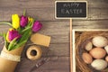 Easter background with eggs in nest and purple and yellow tulips Royalty Free Stock Photo