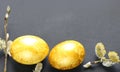 Easter background with golden eggs and willow on a black background. Template for poster, advertisement, poster, postcard. Royalty Free Stock Photo