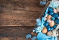 Easter background with marble blue and pastel quail and chicken eggs, decorated with blue feathers and flowers