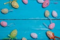 Easter background. Multicolored decorated easter eggs, multi-colored powder on a turquoise background. Free space