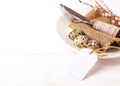 Easter background. Table setting for the holiday of Easter in a rustic style,burlap napkin, quail eggs, fork and knife on a white