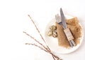 Easter background. Table setting for the holiday of Easter in a rustic style,burlap napkin, quail eggs, fork and knife on a white Royalty Free Stock Photo