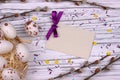 Easter Background with white easter eggs willow branches purple ribbon and space for text.