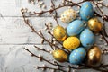 Easter background with willow branches, blue and gold eggs on white wooden table. space for text Royalty Free Stock Photo