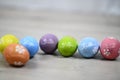 Easter backgrounds with eggs. Bright and colorful Easter eggs lined up horizontally on a white wooden background. Easter egg.