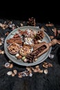 Easter bakery, Stick cookies, Walnuts and Colored eggs.with Pine cones on Ceramic plate