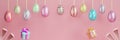 Easter banner, eggs on strings on a pink background. Copy space 3D rendering