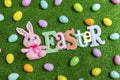 Easter banner letters with scatter plastic Easter eggs and plush bunny