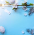Easter banner with painted eggs and spring flowers on light blue backround. Top view, flat lay with copy space