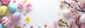 Easter banner with pink, blue and yellow colored eggs. White background and flower