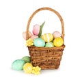 Easter basket of colorful Easter Eggs and flowers isolated on white Royalty Free Stock Photo