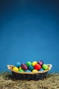 Easter basket with multicolor eggs, blue background