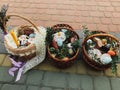 Easter baskets with stylish painted eggs, easter cake, ham,beets, butter, candle with boxwood branches for sanctify at church.