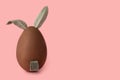 Easter black chocolate bunny over pink background,  creative art concept, close up Royalty Free Stock Photo